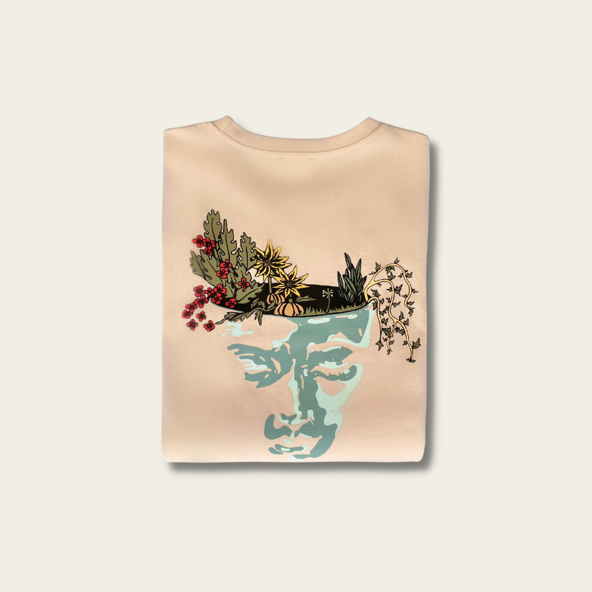 h clothing - sandy tanned tshirt with graphic of face and garden design folded on white background