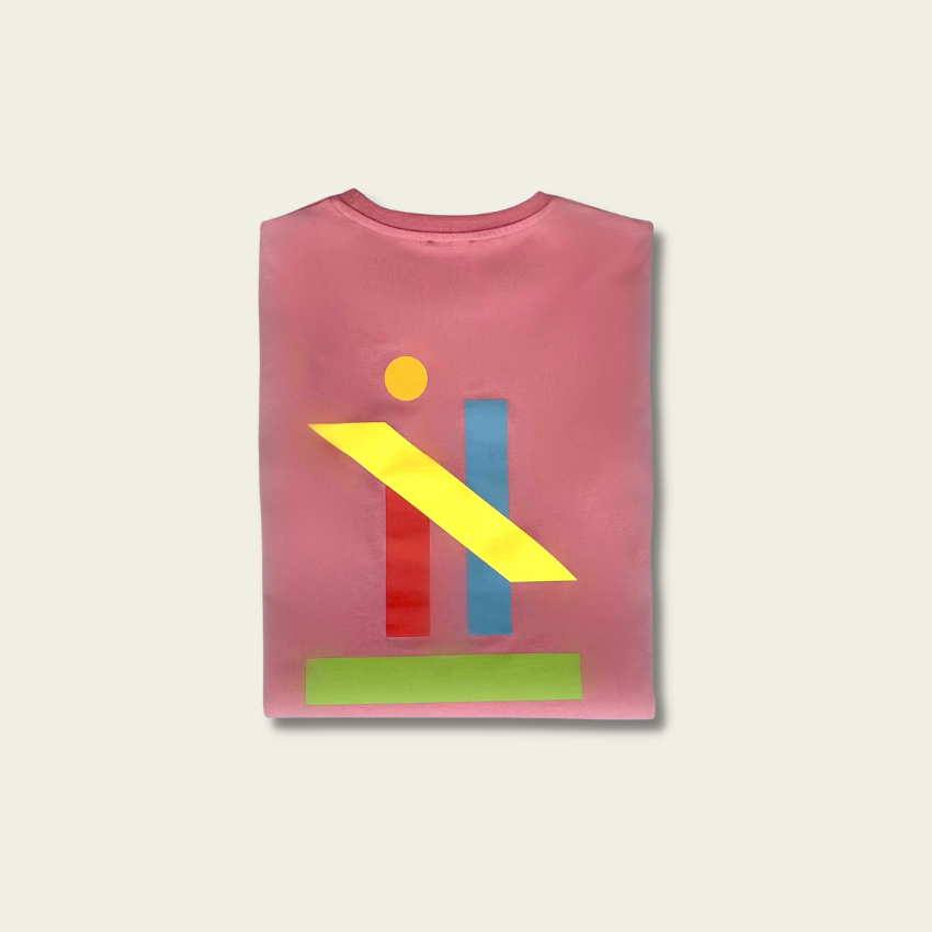 h clothing - folded pastel pink tshirt with graphic of colourful geometric shapes on white background