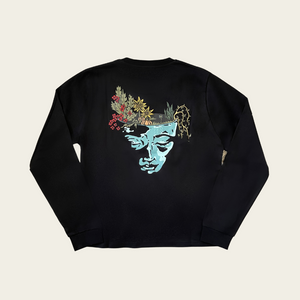 h clothing - flat shot of back of black long sleeved tshirt with graphic of a face and a garden on top of the head
