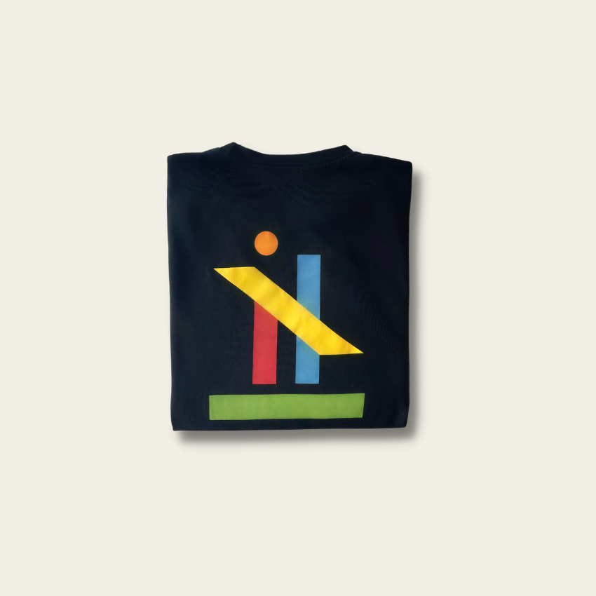 h clothing - flat shot of back of folded black long sleeved tshirt with graphic of colourful geometric shapes