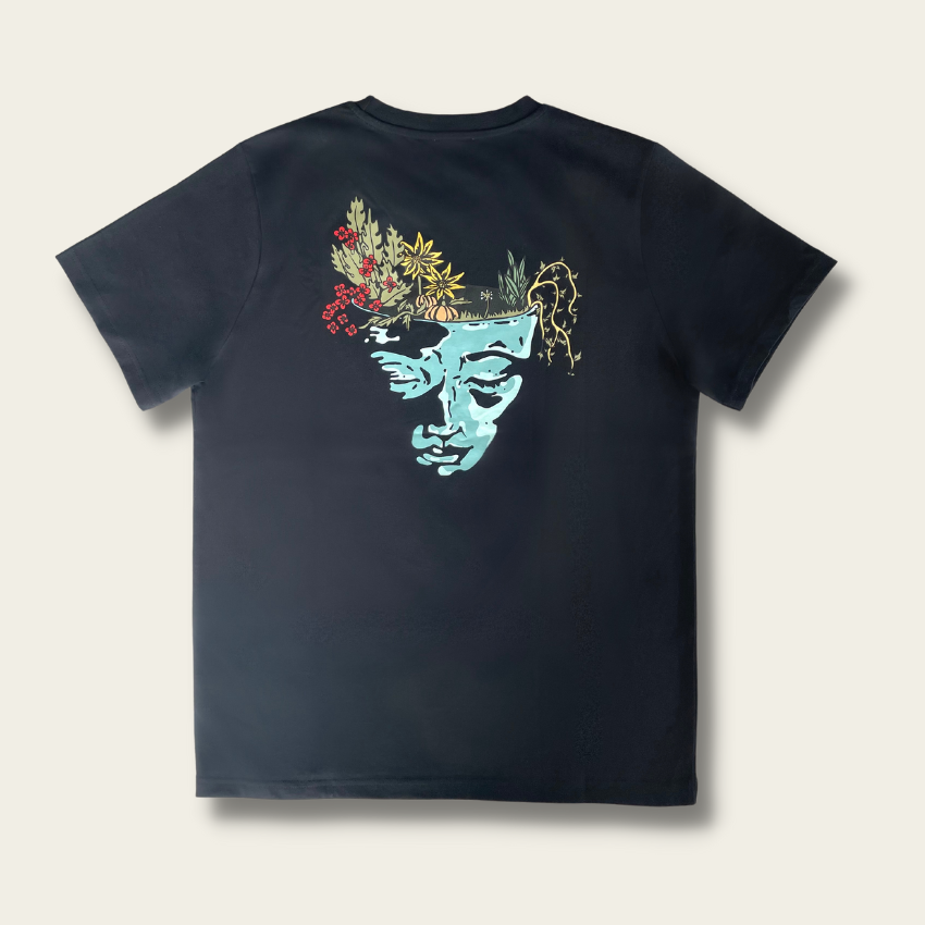 h clothing - flat shot of back of black tshirt with graphic of a face and a garden on top of the head