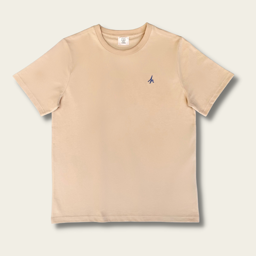 h clothing - flat shot of front of sandy tanned tshirt with blue h logo on left breast