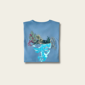 h clothing - flat shot of back of folded flintstone tshirt with graphic of a face and a garden on top of the head