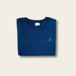 h clothing - flat shot of front of folded navy blue sweatshirt with blue h logo on left breast