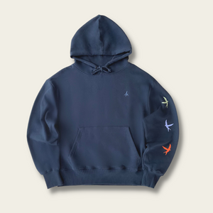 h clothing - flat shot of front of navy hoodie with blue h logo on left breast and colourful birds down the left arm