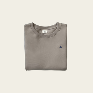 h clothing - flat shot of front of folded heather grey sweatshirt with blue h logo on left breast