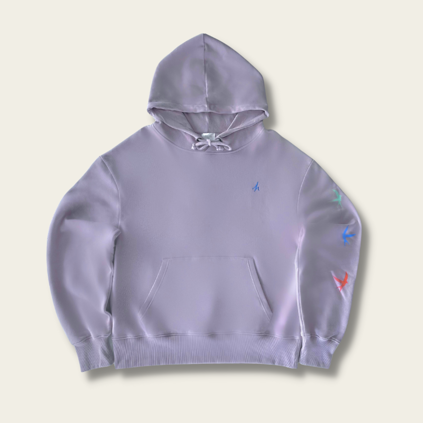h clothing - flat shot of front of light purple hoodie with blue h logo on left breast and colourful birds down the left arm