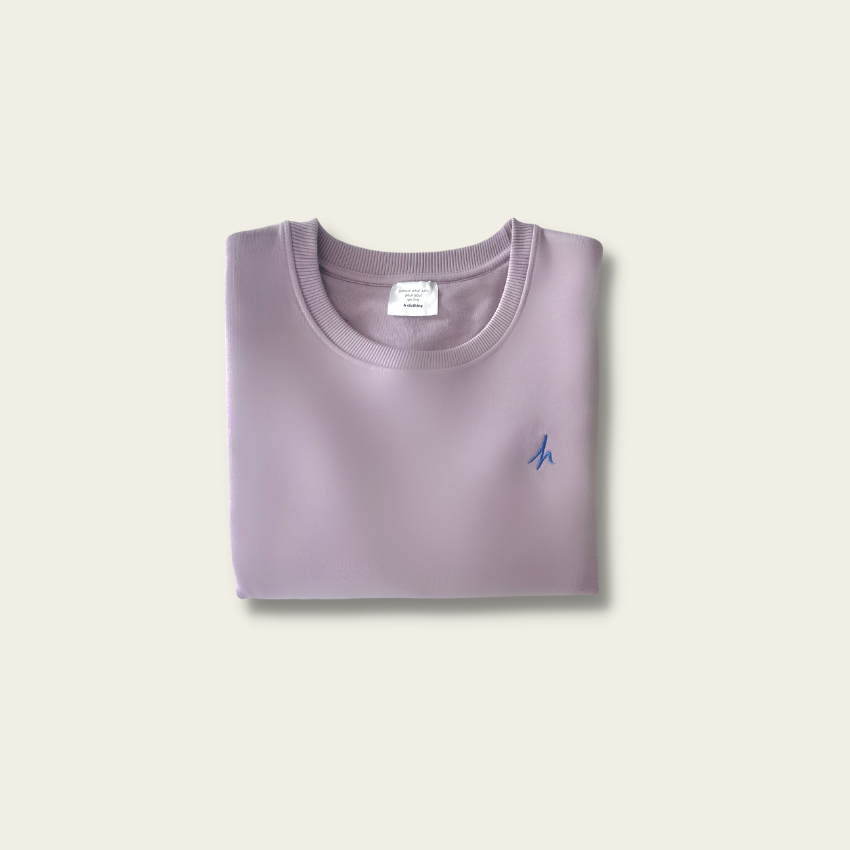 h clothing - flat shot of front of folded light purple sweatshirt with blue h logo on left breast
