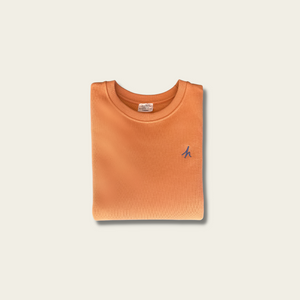 h clothing - flat shot of front of folded pastel orange sweatshirt with blue h logo on left breast