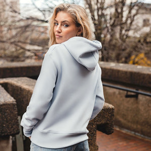 h clothing - female model with back to camera wearing sky blue hoodie