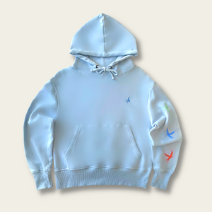 h clothing - flat shot of front of sky blue hoodie with blue h logo on left breast and colourful birds down the left arm