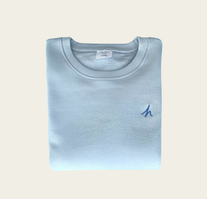 h clothing - folded sky blue sweatshirt with blue h logo on white background