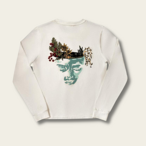 h clothing - flat shot of back of white long sleeved tshirt with graphic of a face and a garden on top of the head