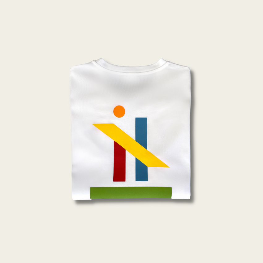 h clothing - flat shot of back of folded white long sleeved tshirt with graphic of colourful geometric shapes