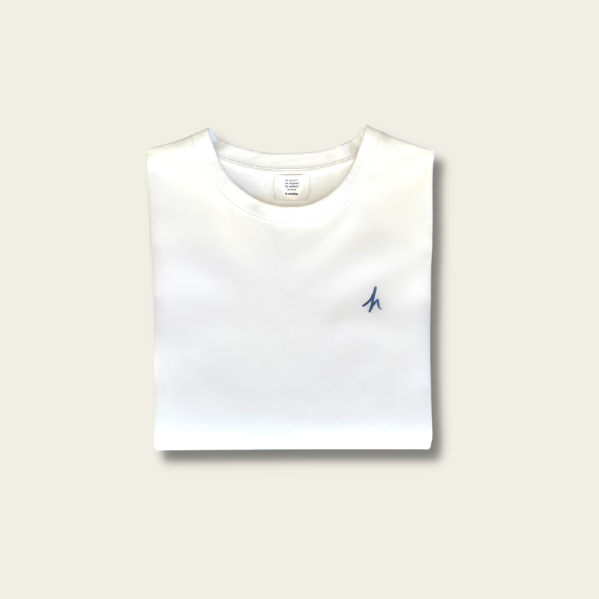 h clothing - flat shot of front of folded white tshirt with blue h logo on left breast