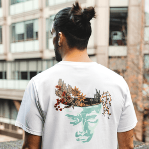 h clothing - male model with back to camera wearing white tshirt with graphic of a face and a garden on top of the head
